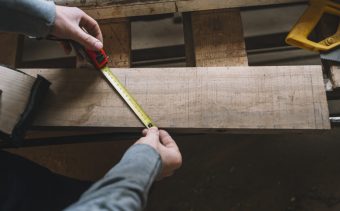 carpentry-concept-with-man-measuring